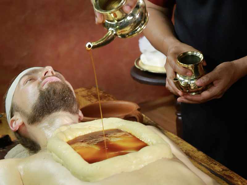 Patient receiving Ayurvedic oil therapy in Hyderabad, enhancing quality of life for MS treatment.